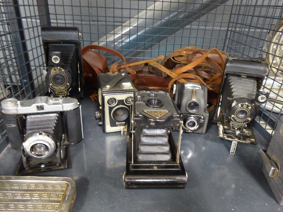 Cage containing vintage cameras including cinecamera