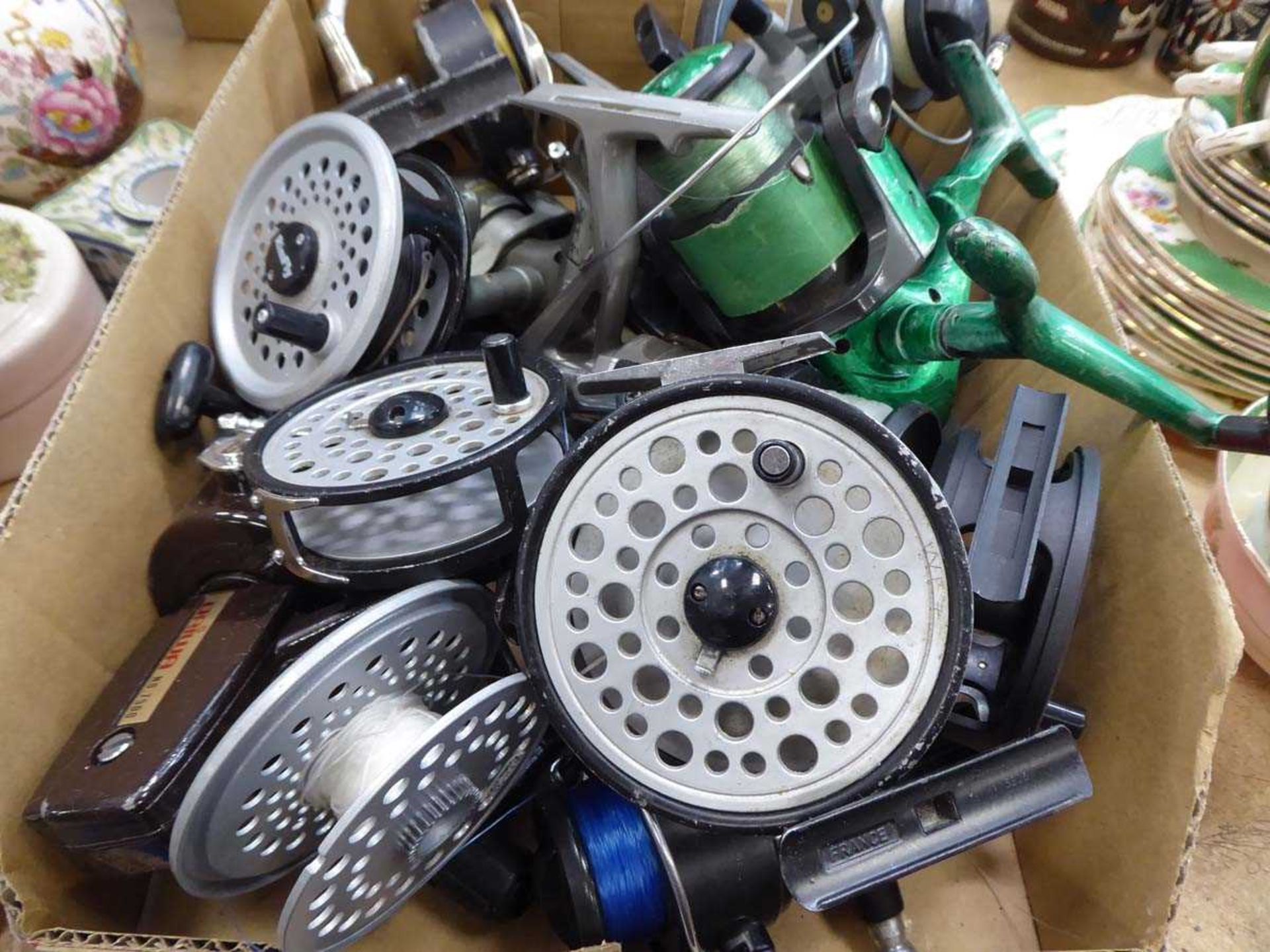 Box of sea fishing and fly fishing reels