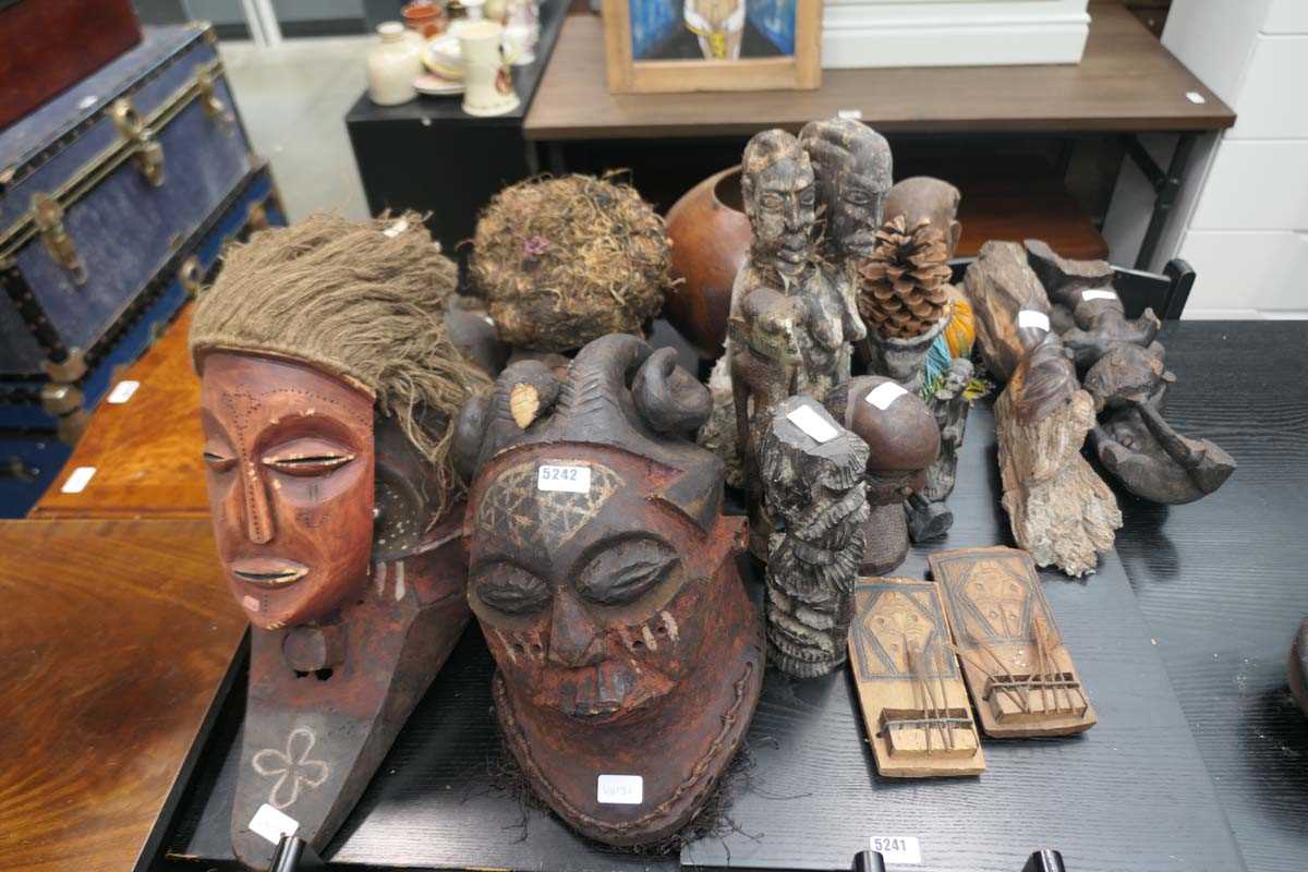 Large quantity of wooden carved tribal masks and figures