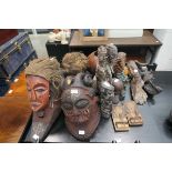 Large quantity of wooden carved tribal masks and figures
