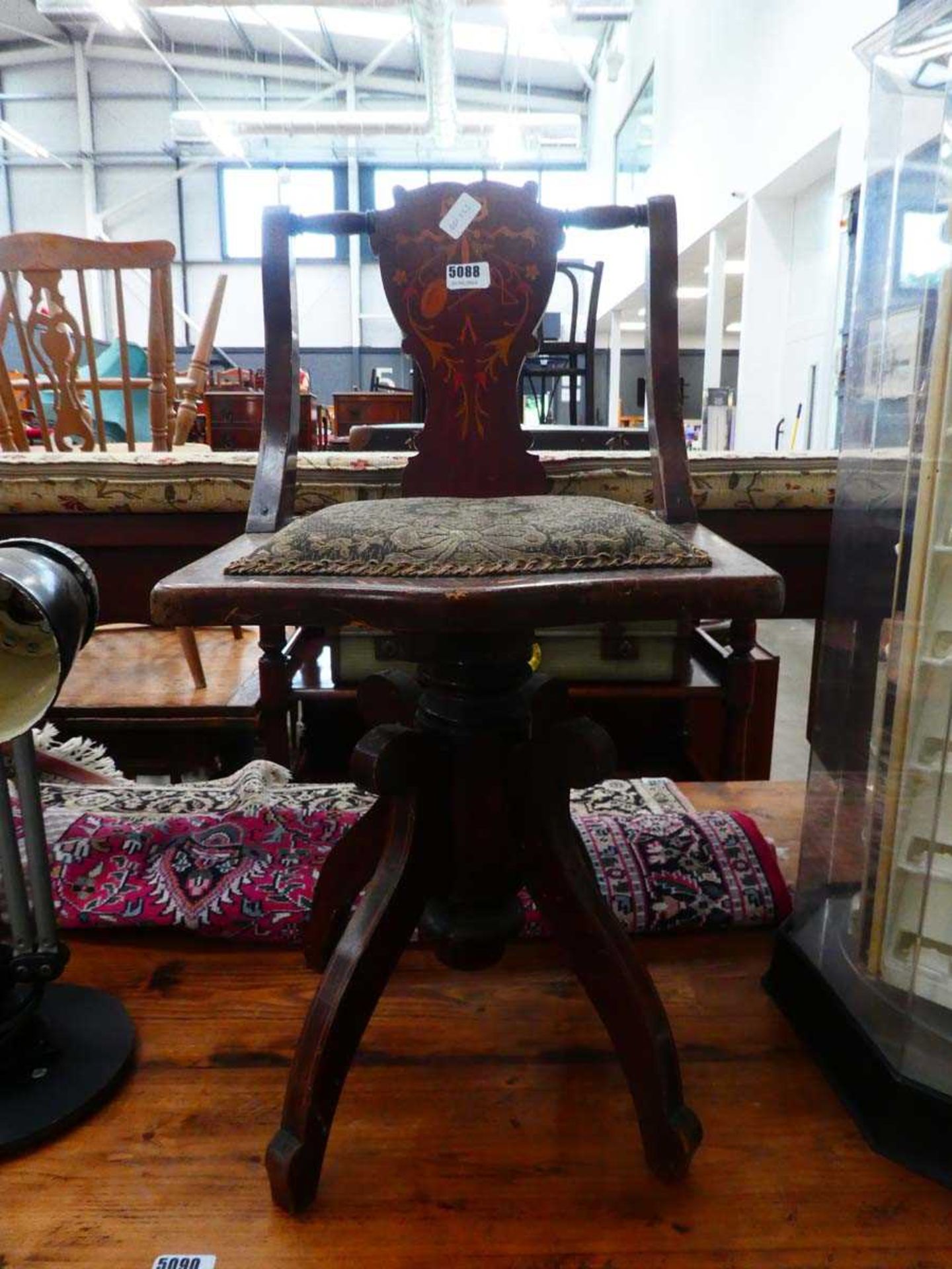 Single dark wood swivel chair with floral upholstery