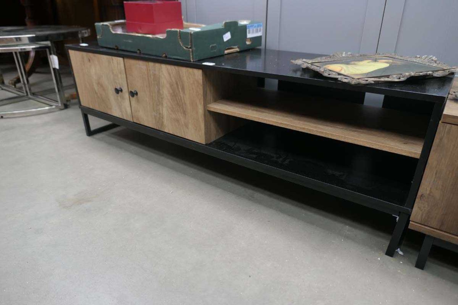 Black low sideboard with 2 wooden doors and shelving unit