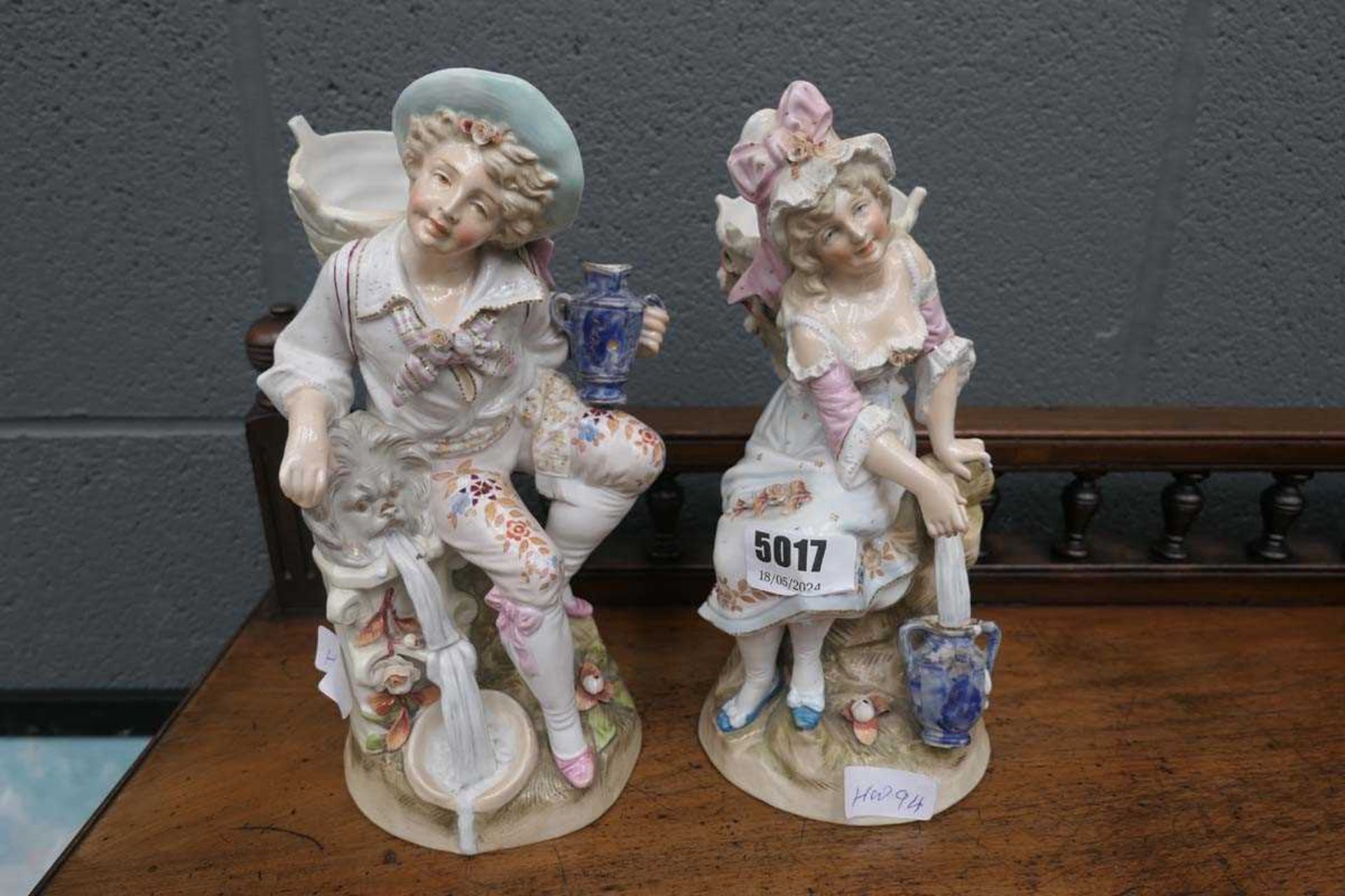 Two ceramic figures of boy and girl with baskets