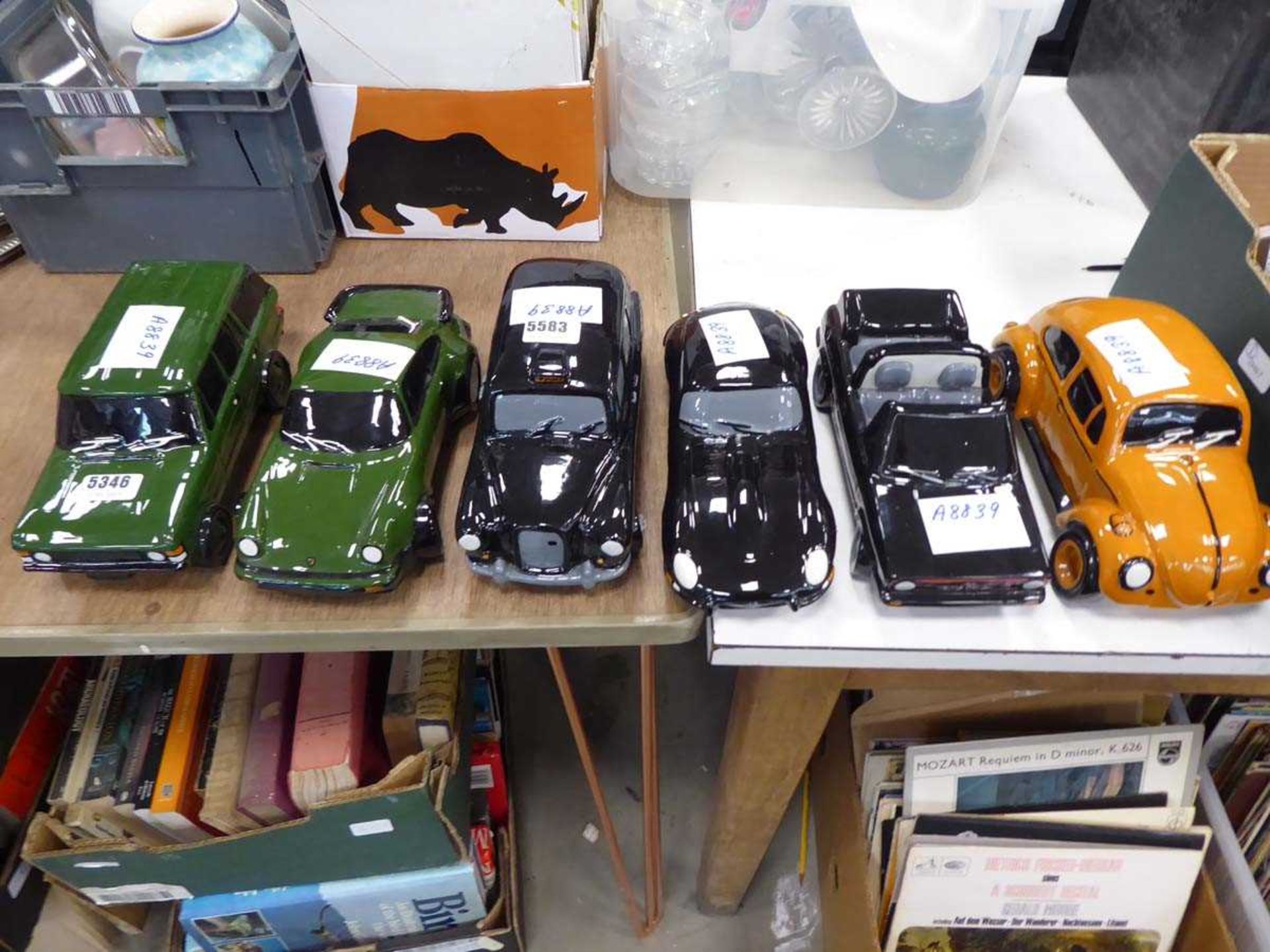 6 assorted ceramic car models to include Beetles, Porsches etc