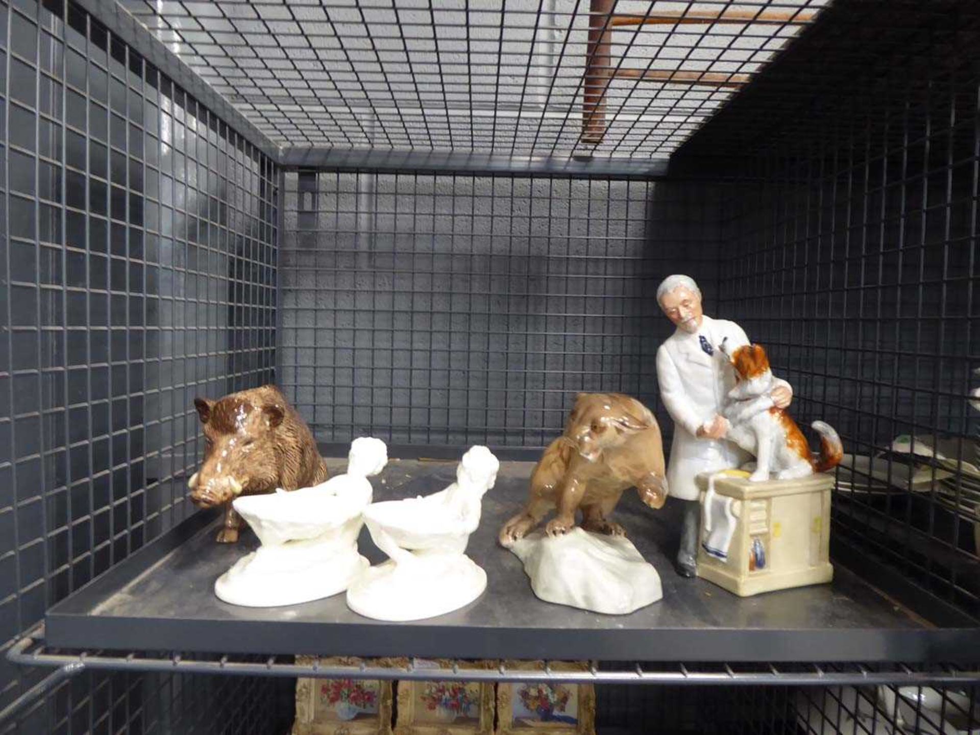 Cage containing a quantity of Royal Doulton and Beswick figurines to include jaguars, wild boars and
