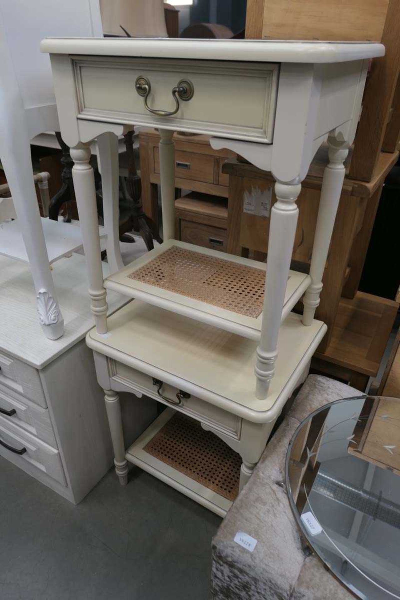 Two cream single drawer bedside cabinets with bergère shelf