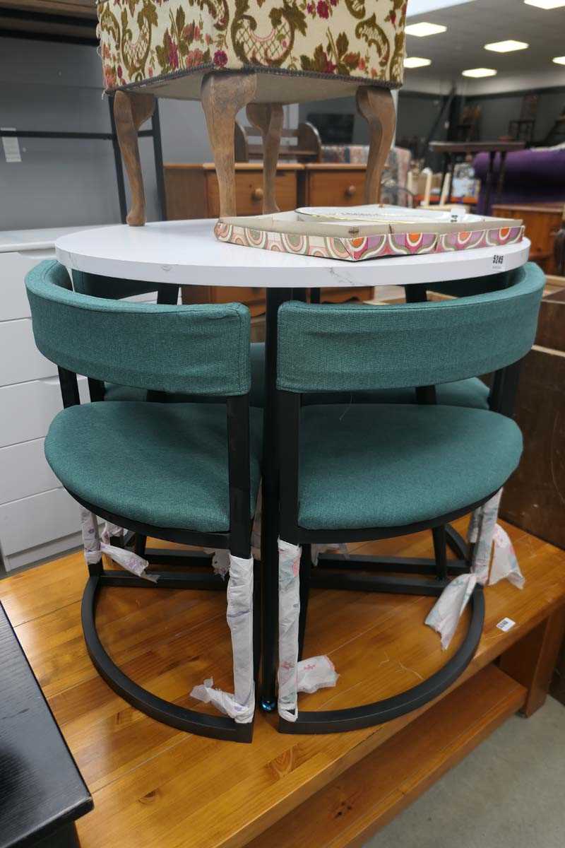 Marble effect table on black supports with 4 green upholstered corner chairs under