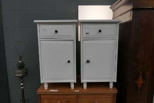Two white bedside cabinets