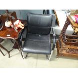 Black leather effect office armchair on chrome base