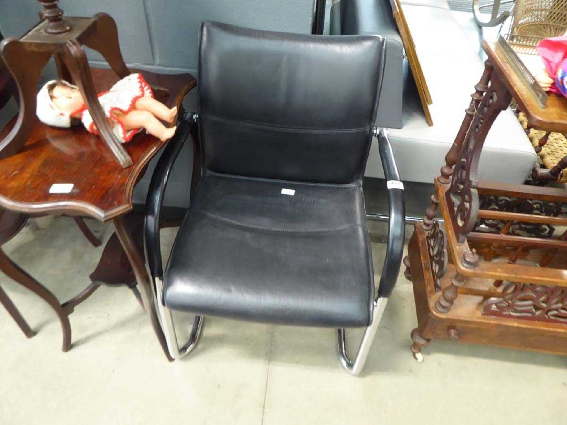 Black leather effect office armchair on chrome base