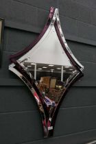 Mirror in the form of a diamond with purple inlaid frame