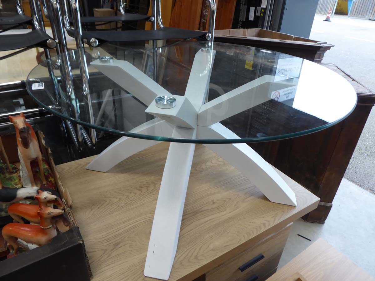 Glass circular topped coffee table on white supports