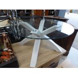 Glass circular topped coffee table on white supports