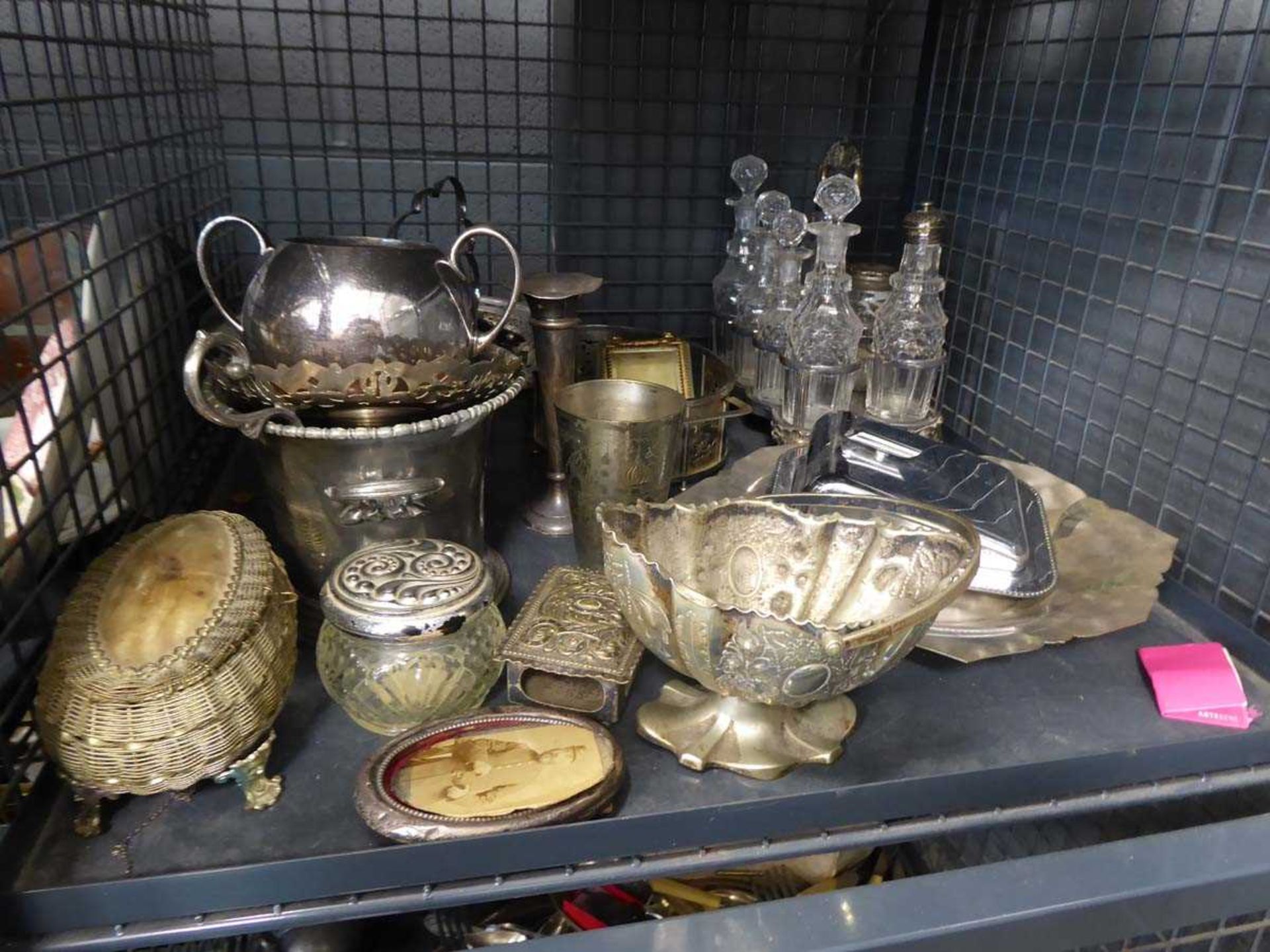 Cage of mainly white metal ware and a condiment tray with cut glass decanters