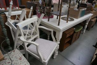 White painted kitchen table with six matching beige upholstered chairs