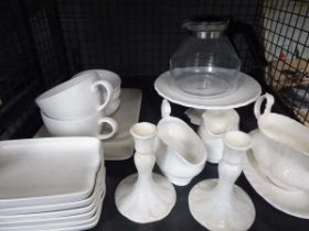 Cage containing white china to include gravy boats, cake stands, large mugs, candlesticks