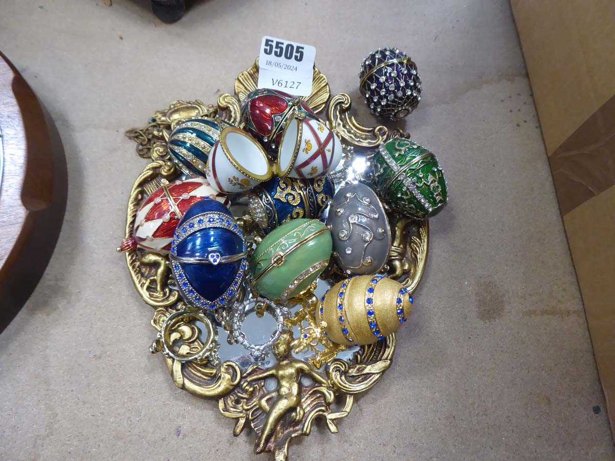 Quantity of collectible egg-shaped trinket boxes and small wall mirror