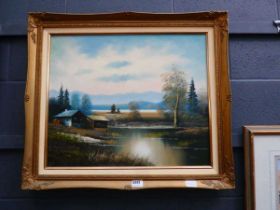 Framed oil on canvas of a water wheel with mountains in background