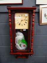 Wall clock in walnut case