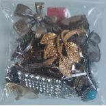 A Collection of Brooches Etc In A Bag. Approximately 250G.