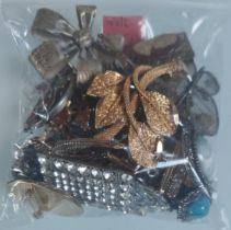 A Collection of Brooches Etc In A Bag. Approximately 250G.