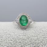 Stylish 1.05 Carat Emerald and Diamond Dress Ring In 18 Carat White Gold