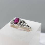 Sterling Silver Celtic-Style Dress Ring Set With An Oval Magenta Cubic Zirconia