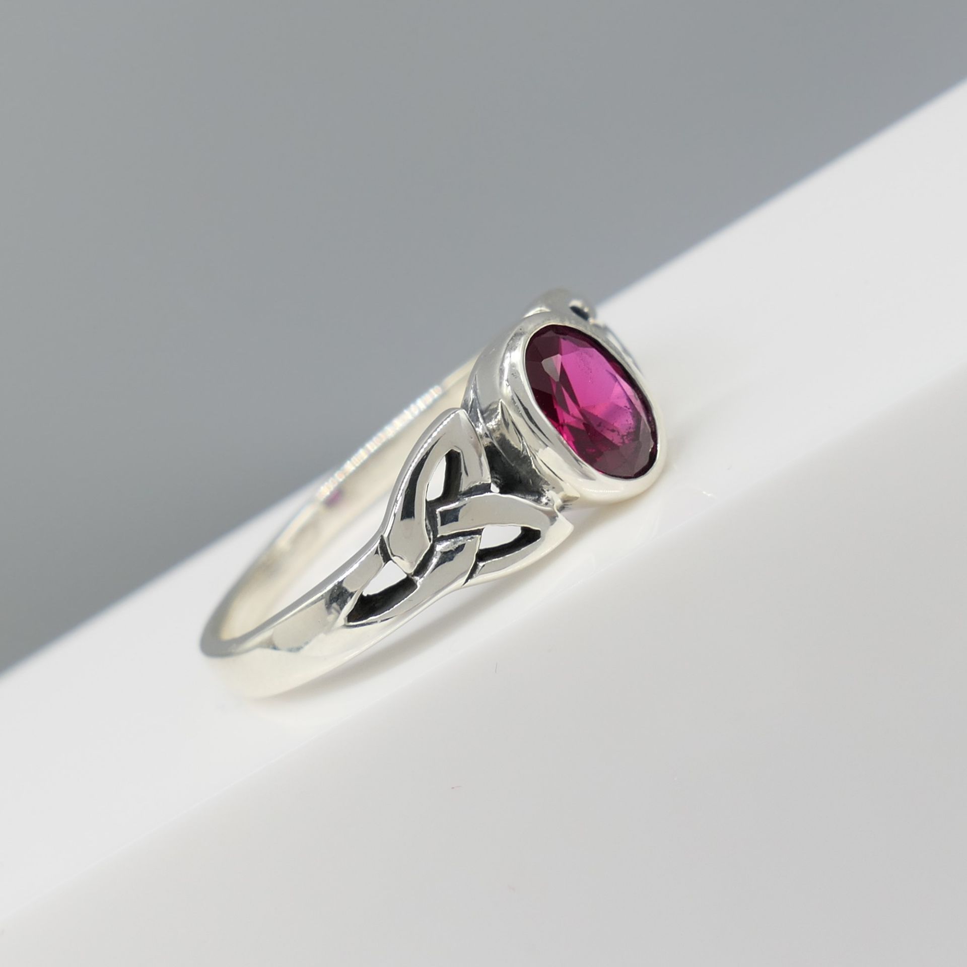 Sterling Silver Celtic-Style Dress Ring Set With An Oval Magenta Cubic Zirconia - Image 3 of 5