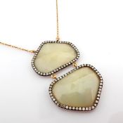 An Exquisite Gold Necklace Detailed With Fancy Cut Rough Sapphire In The Centre and Brilliant Dia...