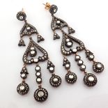 An exquisite old earrings detailed with fancy cut diamonds and gold in silver