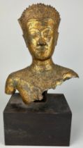 A THAI GILT BRONZE FIGURE OF A MALE HEAD AND UPPER BODY, Mounted on a later wooden base. The