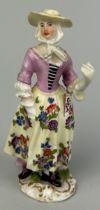 A GERMAN PORCELAIN (PROBABLY DRESDEN) FIGURE OF A MAIDEN, Indistinct blue mark to verso. 12cm H.