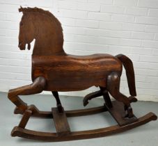 A 19TH CENTURY ROCKING HORSE FROM NUREMBERG IN GERMANY, Primitively carved, the horse having bent