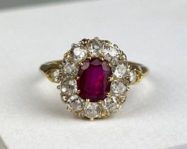 AN 18CT GOLD RING WITH CLAW SET RUBY SURROUNDED BY 14 DIAMONDS, Weight: 4.1gms Ring size 17.