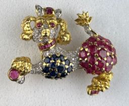 AN 18CT GOLD BROOCH IN THE FORM OF A POODLE DOG SET WITH RUBIES AND SAPPHIRES, 15.37gms