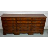 A 19TH CENTURY BANK OF FIFTEEN DRAWERS, 170cm x 81cm x 38cm Each drawer with two brass bat wing