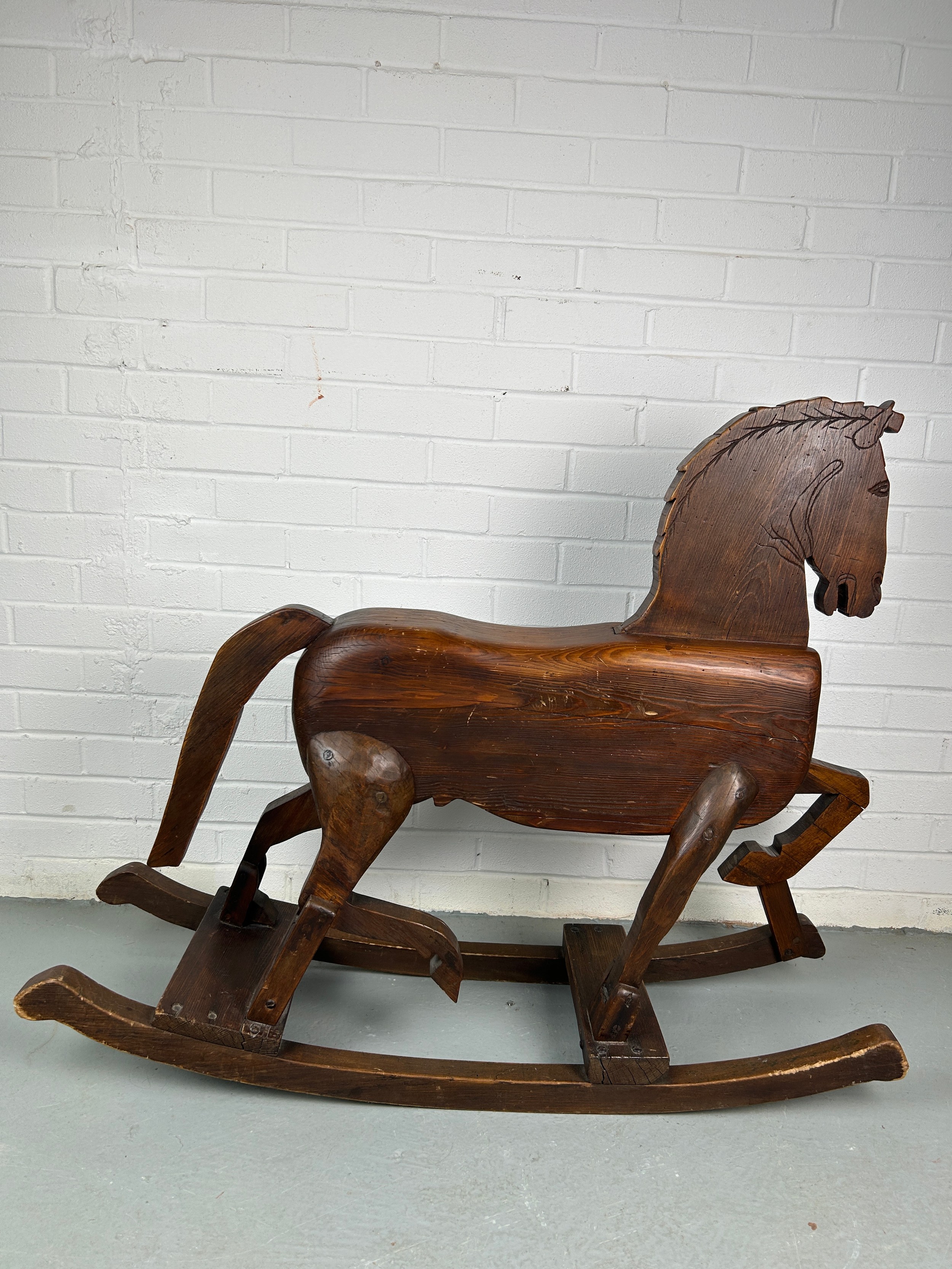 A 19TH CENTURY ROCKING HORSE FROM NUREMBERG IN GERMANY, Primitively carved, the horse having bent - Image 6 of 9