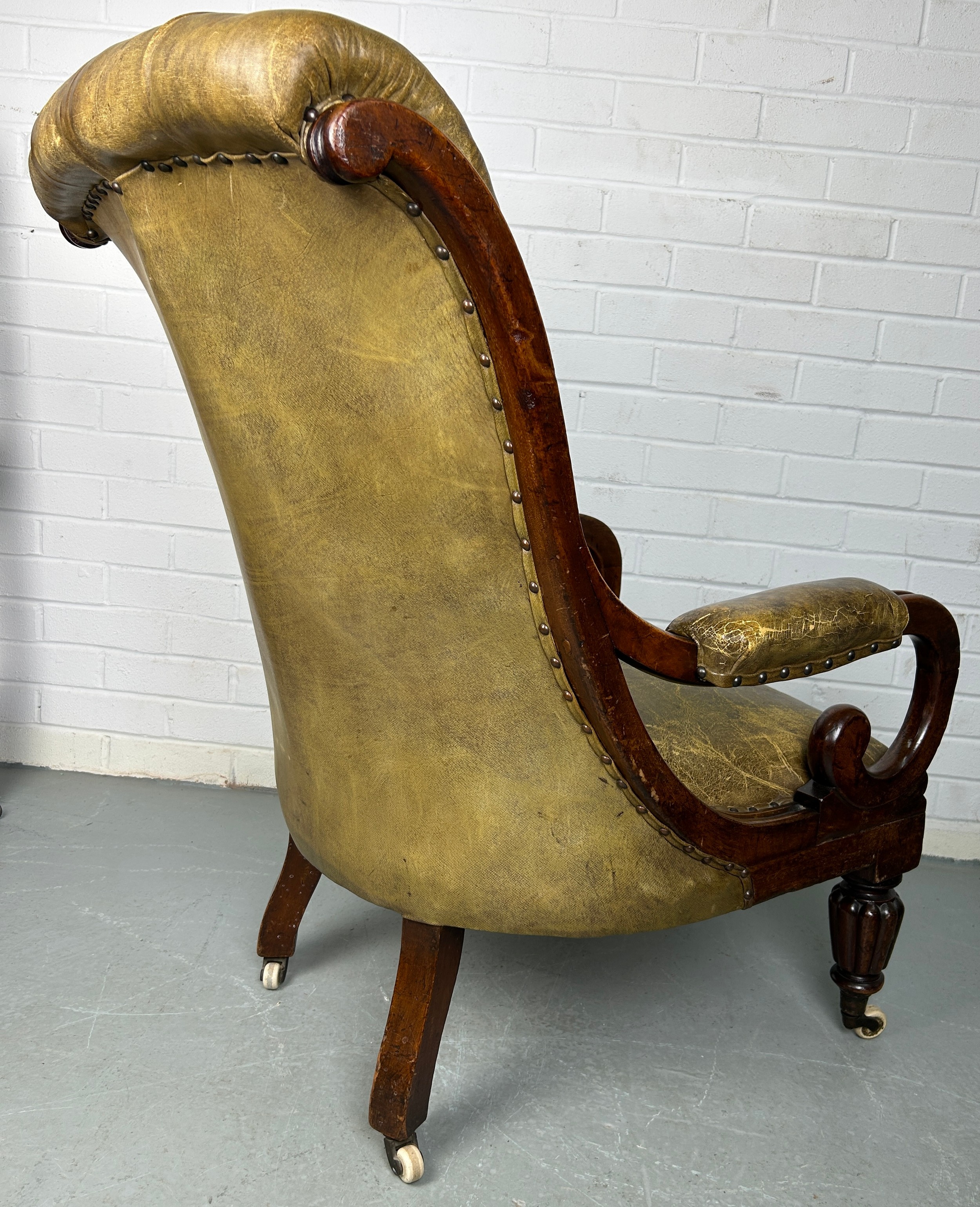 A VICTORIAN LIBRARY GREEN LEATHER UPHOLSTERED SLIPPER ARMCHAIR, Raised on four legs and castors. - Image 3 of 3