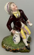 A LATE 18TH CENTURY HOCHST FIGURE OF A BOY CARRYING A JUG AND CUP, Blue wheel mark to verso. 11cm H