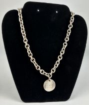 A TIFFANY AND CO SILVER CHAIN WITH INSCRIBED CIRCULAR PENDANT, Weight 64gms