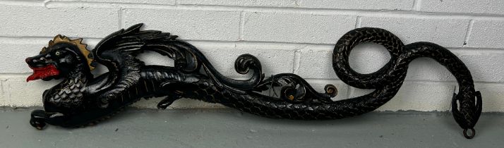 A CHINESE WALL HANGING BLACK PAINTED METAL DRAGON, 90cm x 17cm