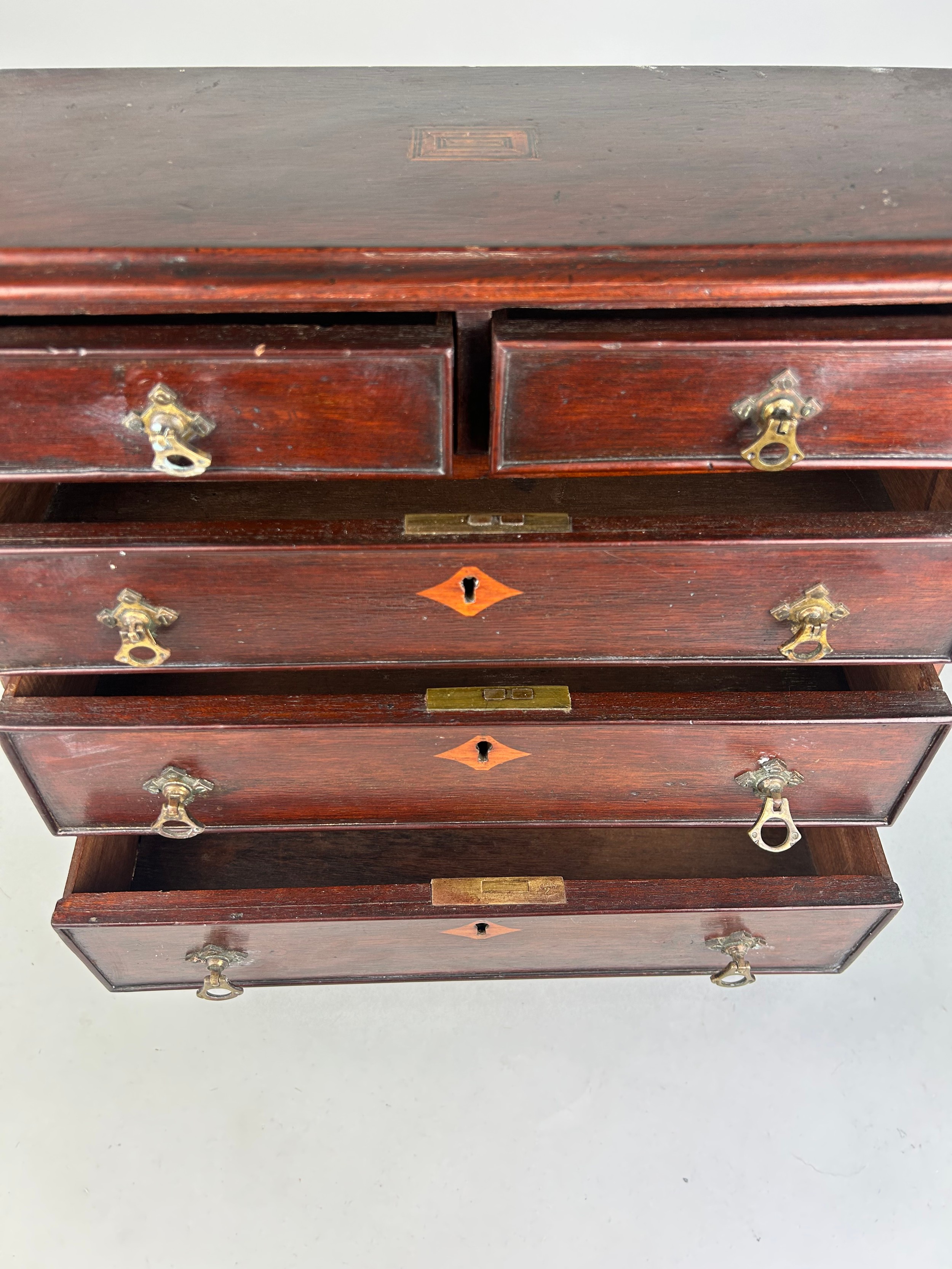 AN EARLY 19TH CENTURY APPRENTICE CHEST OF DRAWERS, With parquetry inlay raised on turned feet. - Image 5 of 5