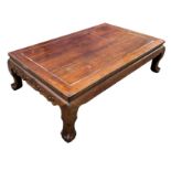 A LARGE CHINESE HONGMU LOW TABLE, Early 20th century, raised on four claw and ball feet. 185cm x