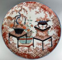 AN EXCEPTIONALLY LARGE AND FINE JAPANESE IMARI PLATE DECORATED WITH LACQUERED FURNITURE AND
