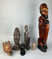 A COLLECTION OF DECORATIVE AFRICAN HEADS AND ORNAMENTS