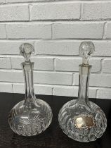 A NEAR PAIR OF GLASS DECANTERS, one with silver sherry label (2)