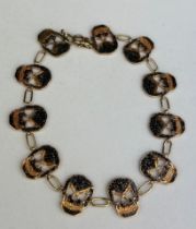 A GOLD SKULL BRACELET WITH WITH BLACK DIAMONDS, 12.2gms