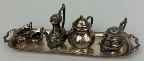 A MINIATURE SILVER TEA SET, Comprising a coffee pot, tea pot, hot water jug, milk pail, sugar jug