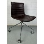 A BROWN LEATHER SWIVEL CHAIR BY ARPEL, 80cm x 47cm x 41cm