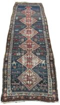 A PERSIAN RUNNER DECORATED WITH FIGURES AND ANIMALS CIRCA 1940'S, 320cm x 105cm